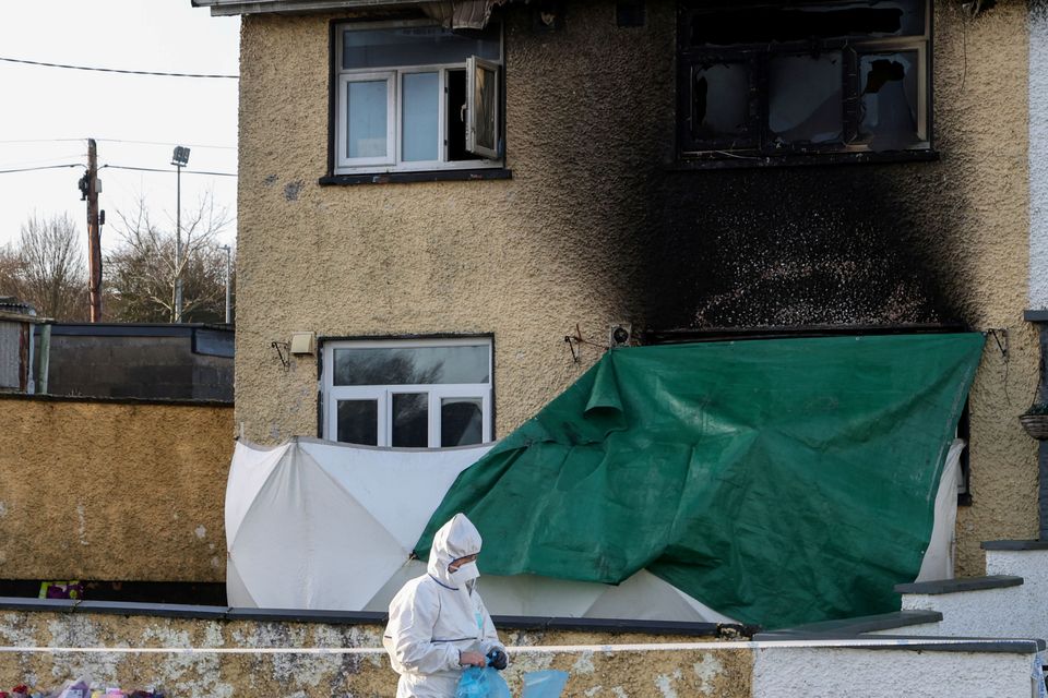 A forensic officer at the scene where little Tadgh Farrell and his grand-aunt Mary Holt were killed last week in an arson attack